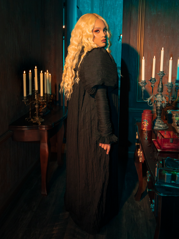 Embrace the somber grace of Victorian mourning attire with this exquisitely crafted gown. The luxurious velvet hugs your form, creating a silhouette that speaks of sorrowful elegance.
