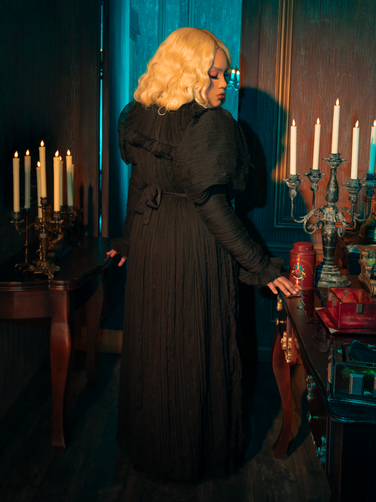 Crafted from the finest black velvet, the Lady Mourning Victorian Gown is a tribute to timeless beauty. Its intricate lace detailing and full, tiered skirt are reminiscent of an era when fashion was both an art and a mystery. 