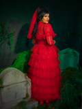 A hauntingly beautiful masterpiece, the Beetlejuice™ Lydia Deetz Wedding Dress in Red weaves layers of tulle and delicate lace into a fiery vision. This gothic gown is made for those who seek to make a dramatic entrance and walk the aisle bathed in passion and intrigue.