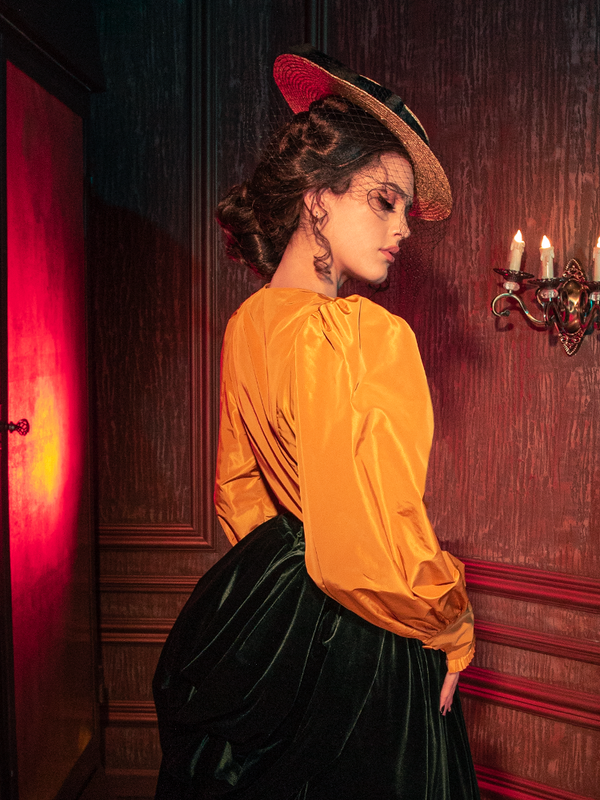 Captivating models embody the haunting allure of the Taffeta Edwardian Blouse in Marigold, a standout creation from the gothic clothing brand La Femme en Noir.
