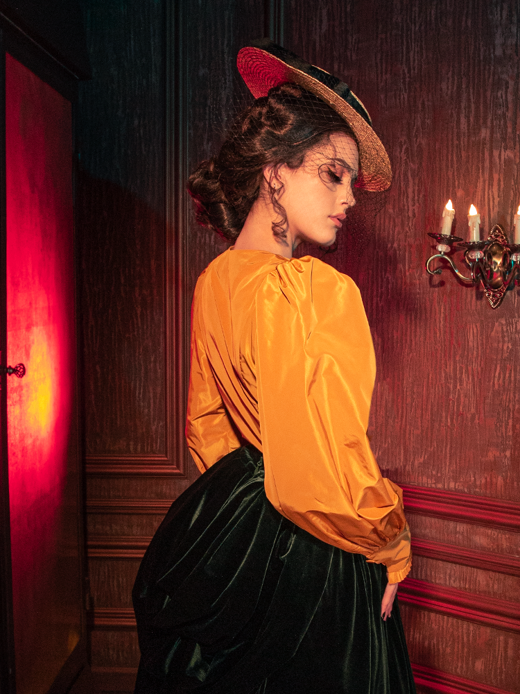 Captivating models embody the haunting allure of the Taffeta Edwardian Blouse in Marigold, a standout creation from the gothic clothing brand La Femme en Noir.