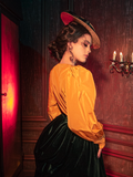 Captivating models embody the haunting allure of the Taffeta Edwardian Blouse in Marigold, a standout creation from the gothic clothing brand La Femme en Noir.