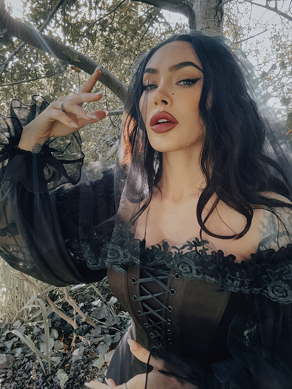 Blending function with dark fashion, this black mini dress features hidden deep side pockets, perfect for the gothic femme fatale on the go.