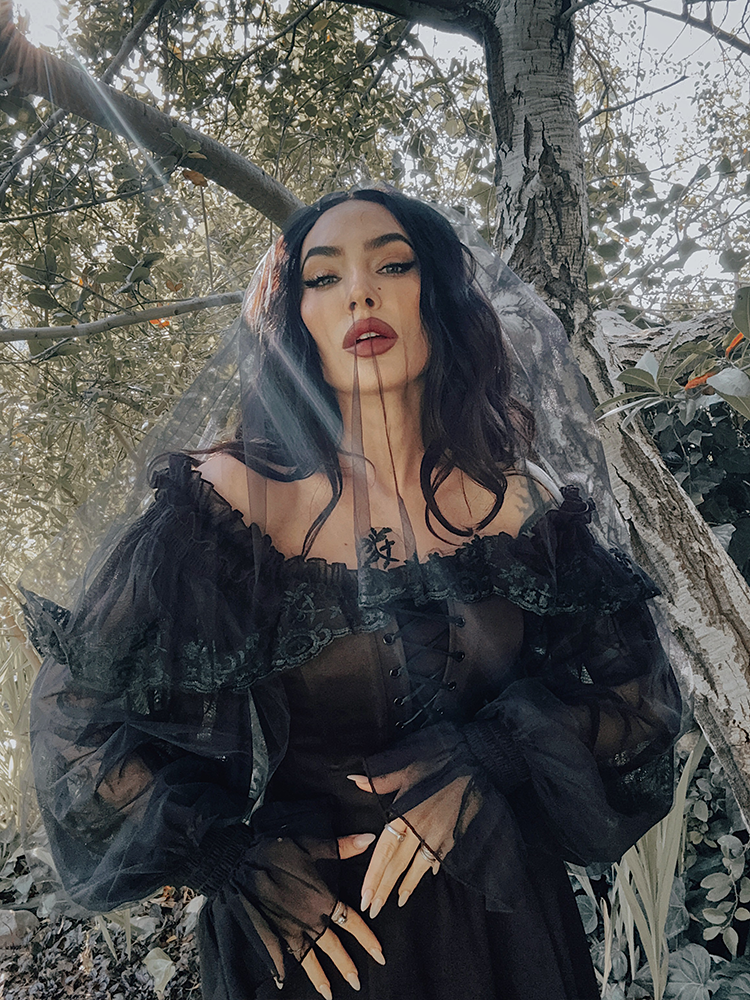 A vision of dark elegance, the Memento Mini Swing Dress in black features a structured ponte bodice and an ethereal ruffled tulle neckline, perfect for the modern Victorian Goth.