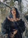 A vision of dark elegance, the Memento Mini Swing Dress in black features a structured ponte bodice and an ethereal ruffled tulle neckline, perfect for the modern Victorian Goth.