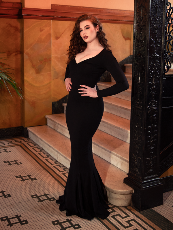 Dark romance defined, the Morticia Dress in Black is crafted for moonlit evenings, its sleek silhouette and trailing hem evoking timeless mystique. Sizes XS–4X.