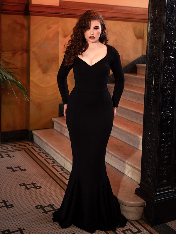 With every movement, the Morticia Dress in Black unveils dark allure, its silhouette sculpting a vision of elegance that transcends time.