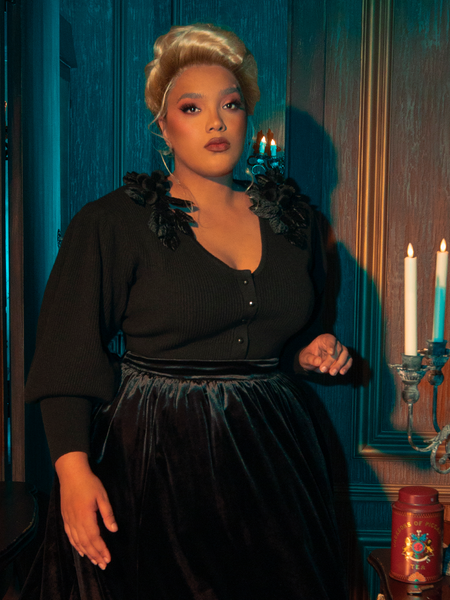 The Victorian Mourning Knit Cardigan in Black is brought to life by gothically stunning female models, who gracefully pose in its intricate details.
