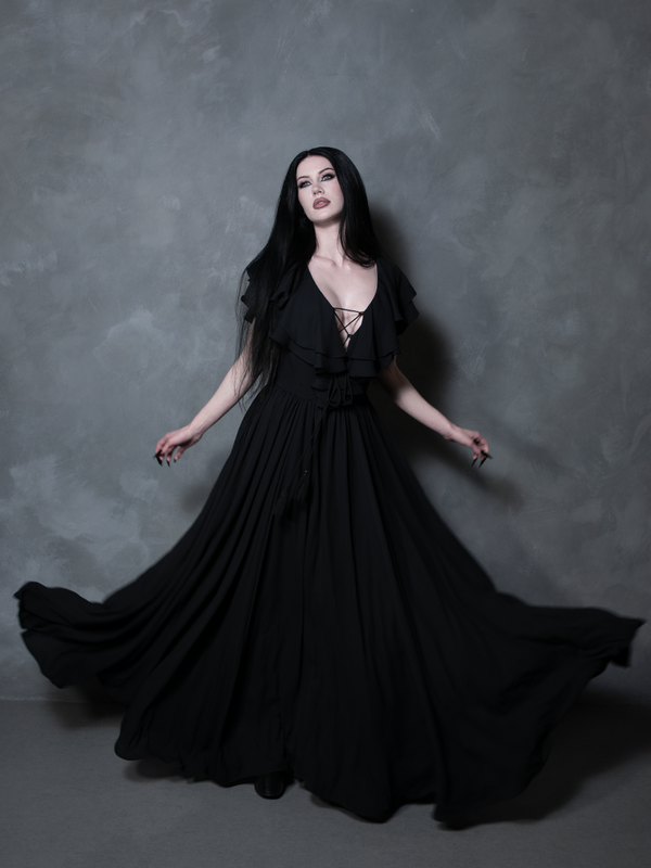 An ethereal embodiment of dark elegance, a female model commands attention in this exquisite black gothic gown, perfectly capturing the essence of modern gothic glamour and dramatic, high-fashion storytelling.