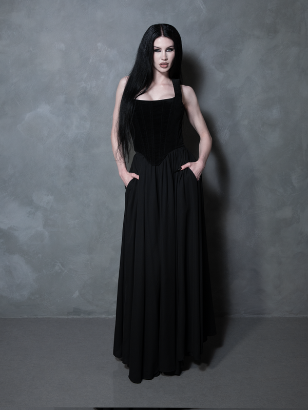 Exuding an air of dark royalty, a female model styles a majestic black chiffon skirt that brings a sophisticated, high-end alternative sensibility to the forefront.