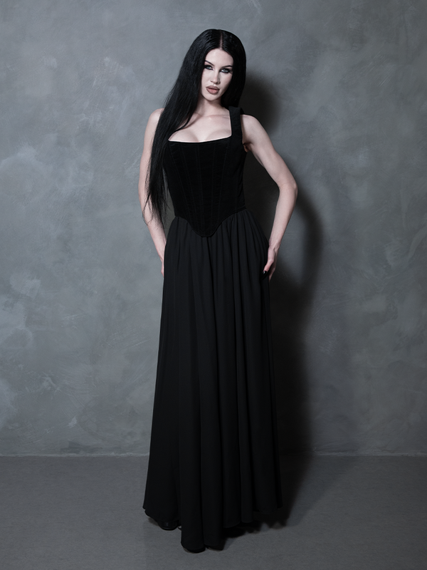Perfect for an evening of dark glamour, a female model elevates her wardrobe with an exquisite black maxi skirt that embodies the height of luxury gothic clothing.