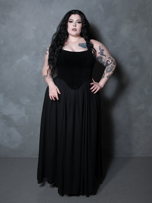 Wrapped in midnight enchantment, a female model channels a deep, poetic romance while showcasing a premium black chiffon skirt designed for the unapologetic dark vixen.