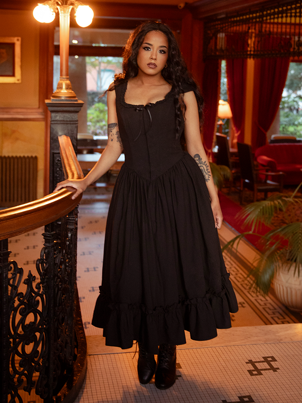With a bodice kissed by antique lace and a skirt that sways like a forgotten waltz, this dress turns darkness into desire.