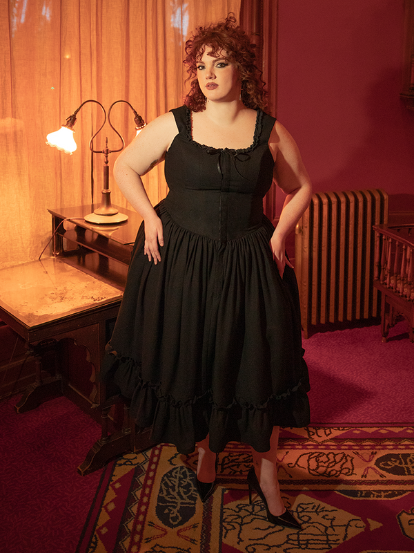Draped in antique black, this dress captures the allure of forgotten eras—perfect for gothic queens and vintage romantics alike.