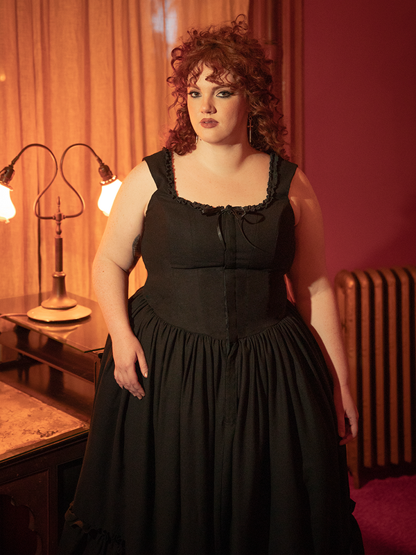 Bathed in shadows, this antique black dress is your invitation to midnight elegance and forbidden grace.