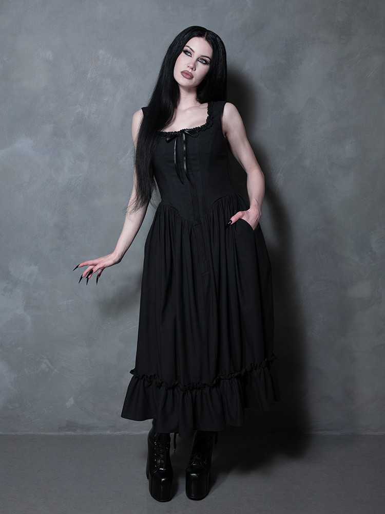 Exuding an irresistible, mysterious charm, a female model perfectly defines gothic style clothing in the Nightshade Underpinning Dress in Antique Black.