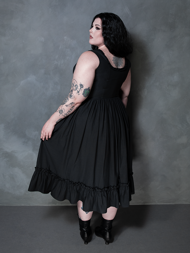 A female model masterfully showcases the dark elegance of alternative evening wear in the Nightshade Underpinning Dress in Antique Black.