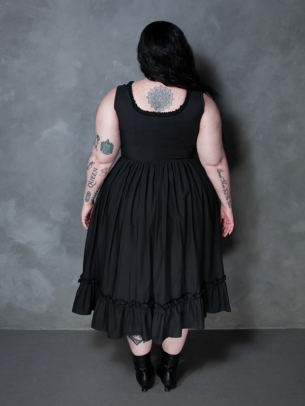 A female model redefines gothic style clothing with a look of supreme luxury in the Nightshade Underpinning Dress in Antique Black.