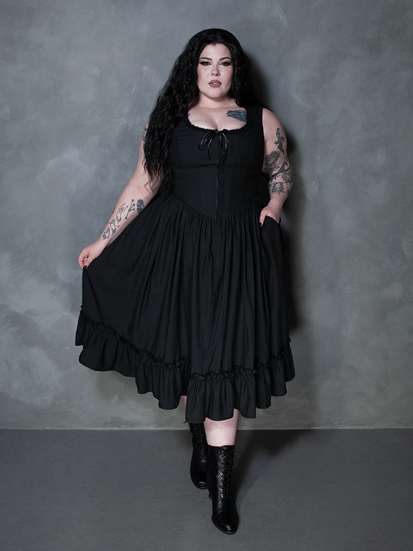 The epitome of dark luxury is achieved as a female model wears the exquisite Nightshade Underpinning Dress in Antique Black.