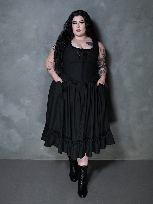 Wrapped in the rich depths of gothic glamour, a female model looks unforgettable in the Nightshade Underpinning Dress in Antique Black.