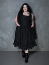 Wrapped in the rich depths of gothic glamour, a female model looks unforgettable in the Nightshade Underpinning Dress in Antique Black.