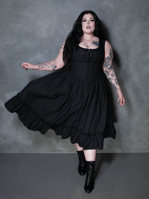 Radiating an enchanting Whimsigoth energy, a female model looks effortlessly mystical in the Nightshade Underpinning Dress in Antique Black.