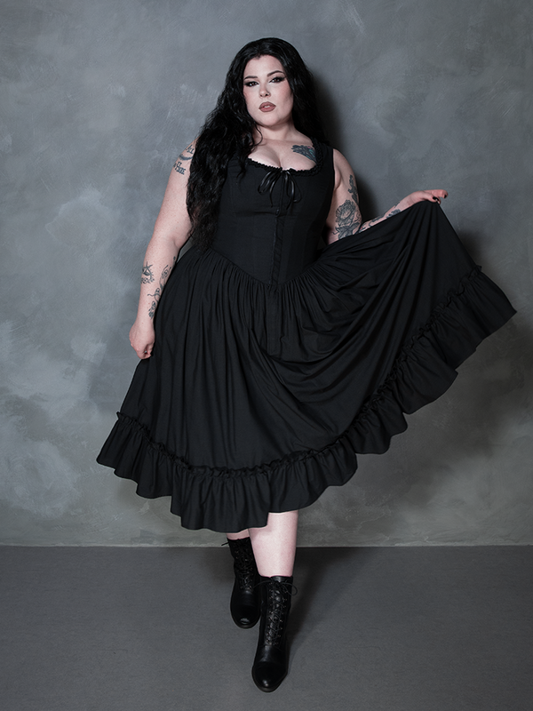 Capturing a moody, ethereal aesthetic, a female model looks utterly spellbinding in the Whimsigoth-inspired Nightshade Underpinning Dress in Antique Black.