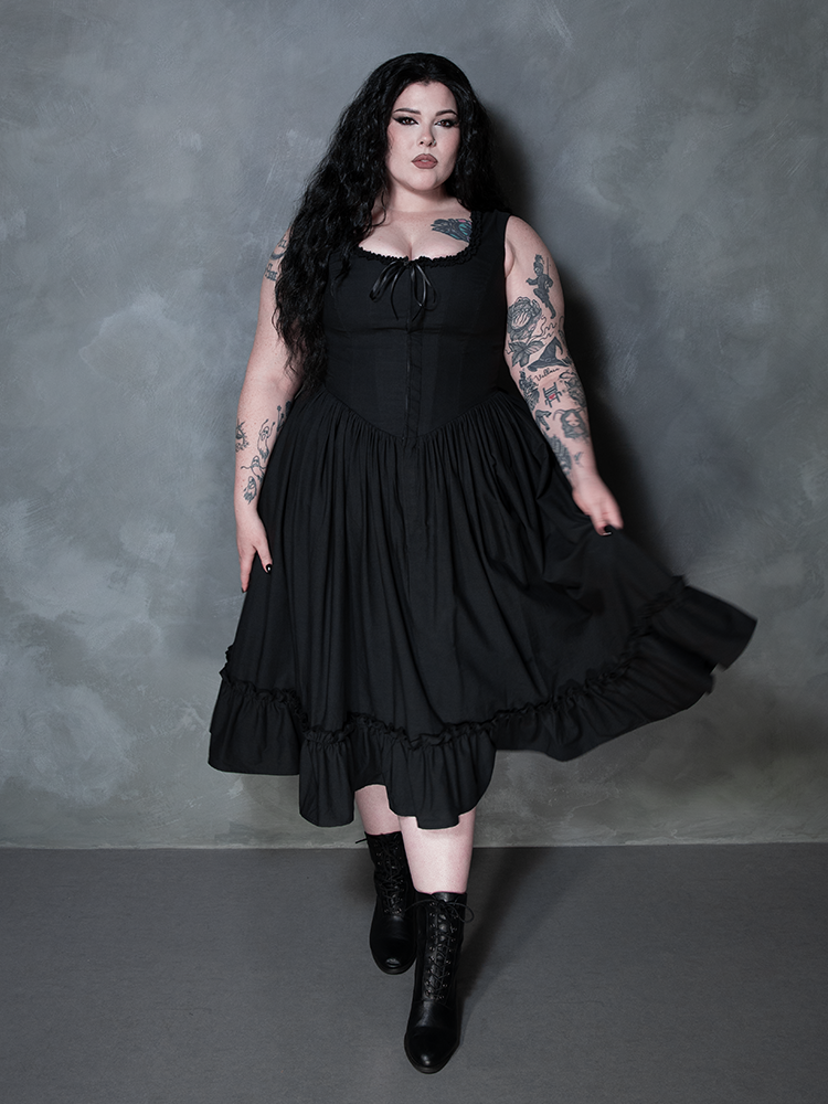 Seamlessly blending alternative edge with high-end luxury, a female model showcases the Whimsigoth charm of the Nightshade Underpinning Dress in Antique Black.