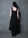 Exuding a sultry, mysterious confidence, a female model looks effortlessly chic in the Nightshade Underpinning Dress in Antique Black.