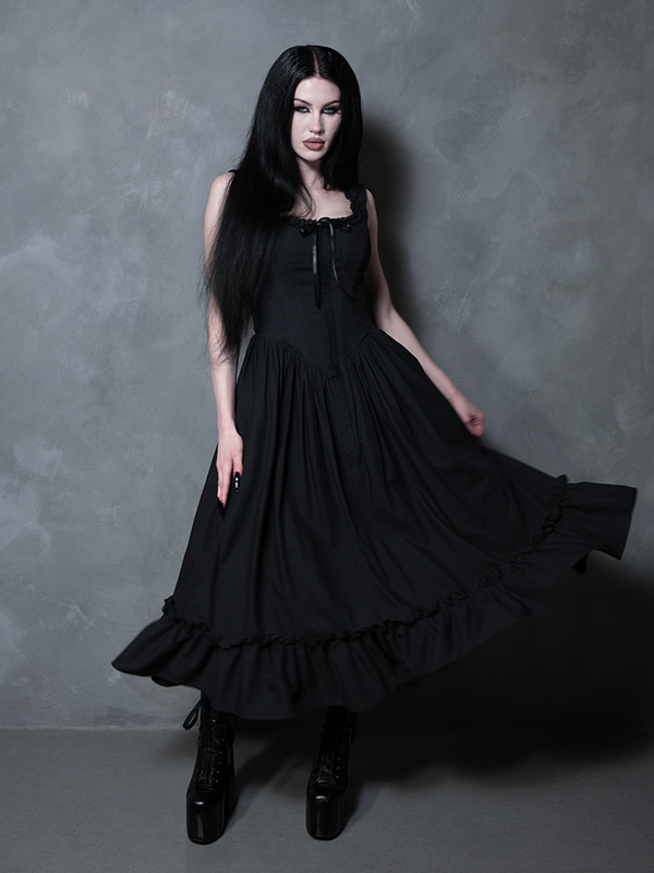 Exuding a regal yet dark confidence, a female model perfectly represents the allure of gothic style dresses in the Nightshade Underpinning Dress in Antique Black.