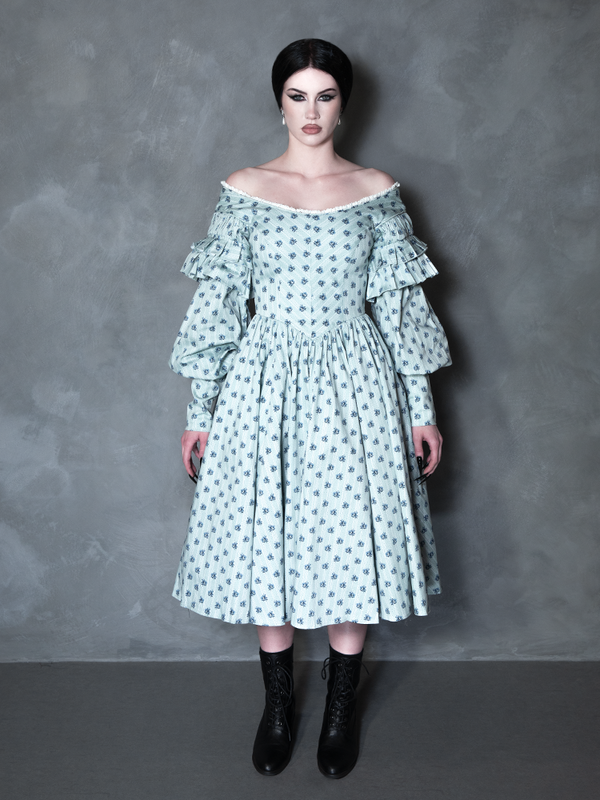 A gothic glamour muse radiates sophisticated darkness, her romantic alternative outfit perfectly complemented by an intricate, vintage-inspired patterned gown.