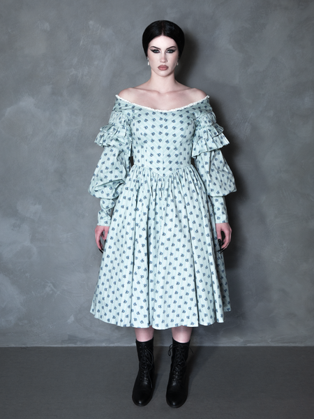 A gothic glamour muse radiates sophisticated darkness, her romantic alternative outfit perfectly complemented by an intricate, vintage-inspired patterned gown.