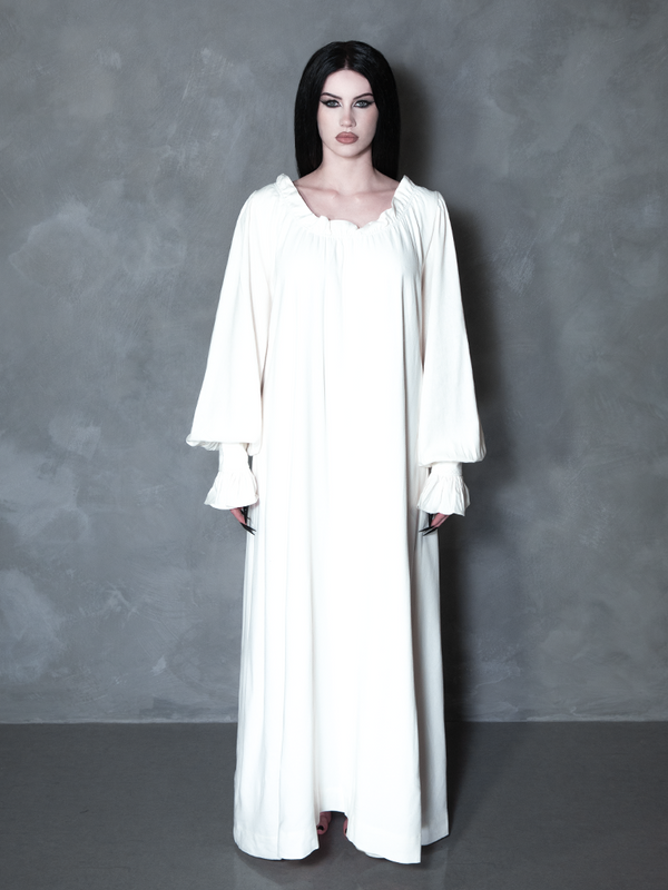 A gothic glamour muse radiates sophisticated darkness, her romantic alternative outfit perfectly complemented by an intricate, vintage-inspired pale gown.