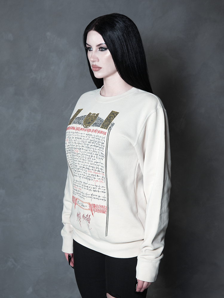 Enveloped in nocturnal mystery, a model styled in dramatic gothic clothing captures the ultimate essence of classic noir horror with a striking, comfortable bone-white pullover.
