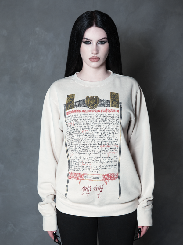A female model channels high-fashion vampire romance, her darkly enchanting ensemble centered around a premium piece of gothic apparel bearing a sinister document design.