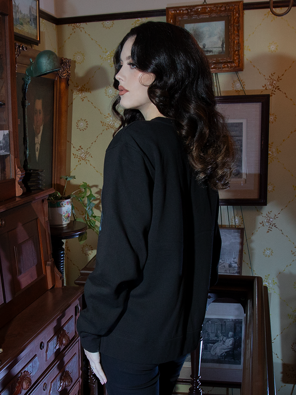 Envelop yourself in timeless gothic allure with this sweatshirt. The Nosferatu castle design on rich black fabric evokes chilling yet cozy sophistication.
