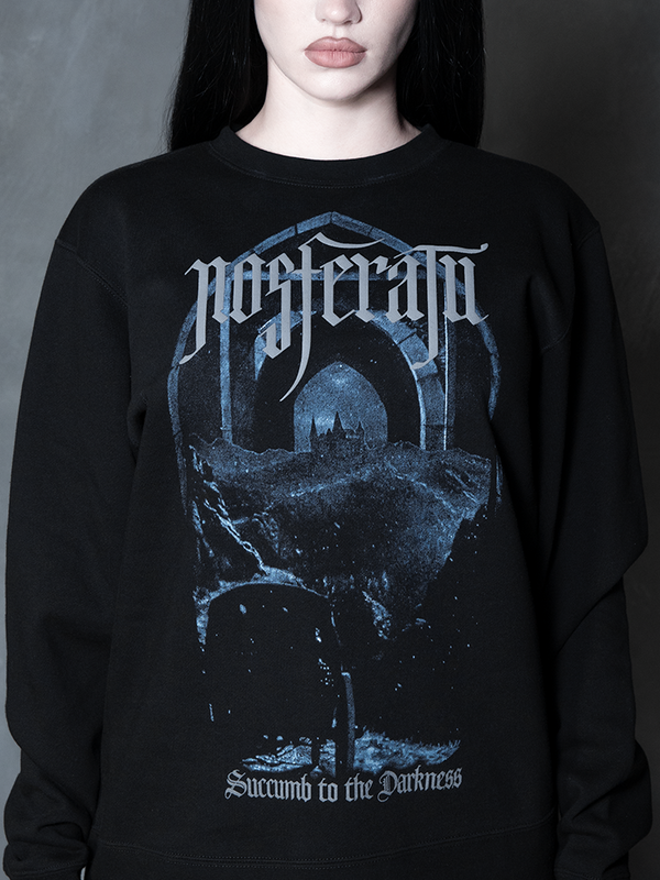 Steeped in romantic melancholy, a model styled in Whimsigoth inspired clothing showcases a comfortable black pullover that captures the timeless spirit of gothic horror.