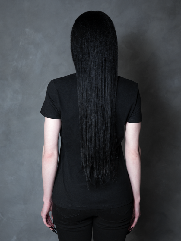 A gothic glamour muse radiates sophisticated darkness, her romantic alternative outfit perfectly complemented by an intricate, occult-inspired fitted top.