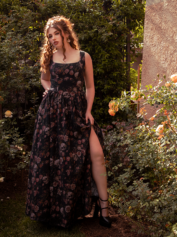 The Novella Maxi Dress in Decayed Beauty Print flows like twilight mist, its moody florals weaving romance into every step.