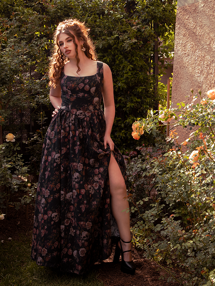 The Novella Maxi Dress in Decayed Beauty Print flows like twilight mist, its moody florals weaving romance into every step.