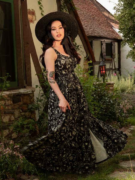 Perfect for woodland rituals, the Novella Maxi Dress in Cottage Witch Toile Print drapes the figure in a tapestry of arcane charm.