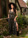 The Novella Maxi Dress in Cottage Witch Toile Print conjures a world of candlelight and secrets, its toile patterns rich with gothic whimsy.