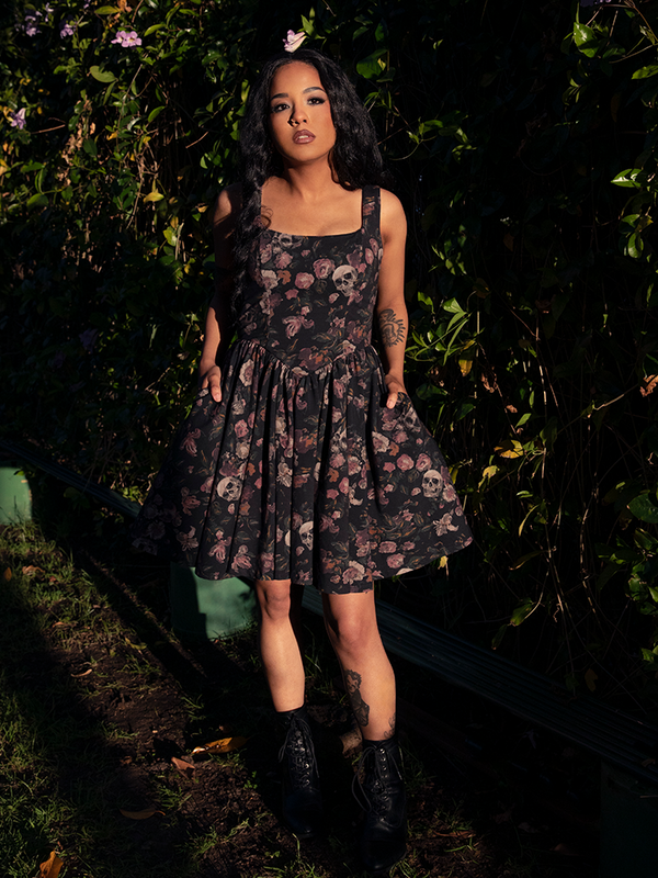 A modern ode to decay and beauty, this mini dress drapes the figure in moody florals, blending sweetness with a touch of shadow.
