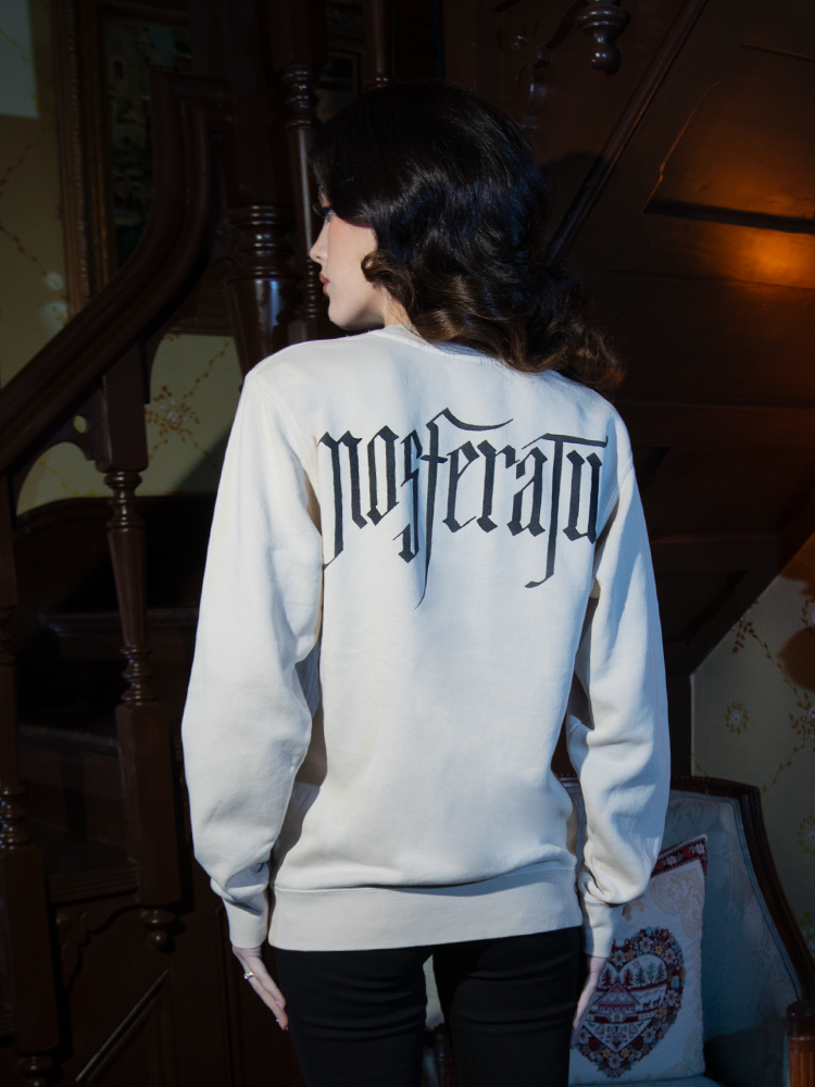 Perfect for layering with dark accessories, the Nosferatu Contract Sweatshirt in Bone features a chilling design inspired by the iconic vampire.