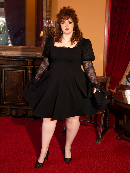 Evoking medieval romance, this gown sways with timeless charm and dark sophistication.