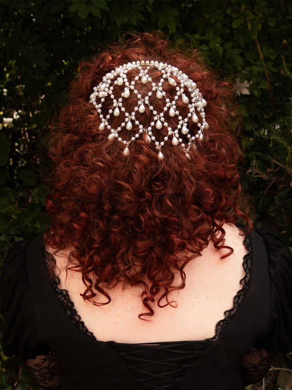 Pearls descend from polished silver like whispered starlight, transforming the hair into a vision of gothic romance. Light on the crown, ideal for extended wear; gently wipe clean.