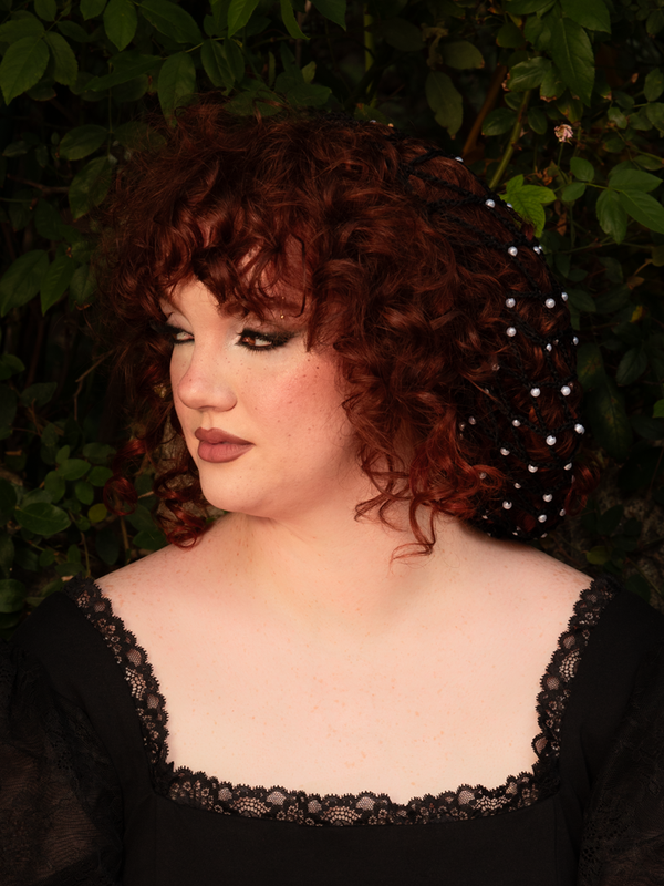 Whispering of moonlit salons and waltzes long forgotten, this Black Hair Net with Pearls crowns your tresses in vintage splendor. Each lustrous pearl glimmers like a captured star, weaving elegance into every strand.