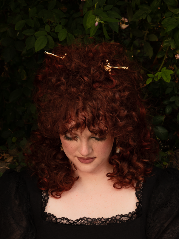 Against a backdrop of black lace, the gold sword hair pin glows softly, its blade slender and fierce. The perfect union of power and grace, it transforms every strand into a statement of gothic grandeur.