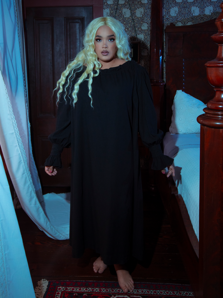 Radiating an enchanting Whimsigoth energy, a female model looks effortlessly mystical in the fluid Victorian Sleeping Dress in Black.