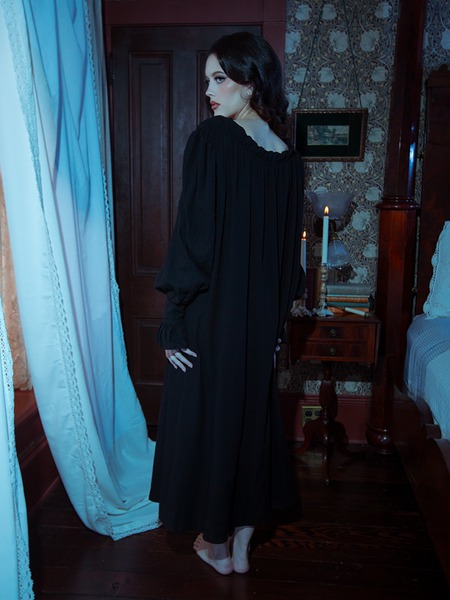 Elegance reimagined—this black Victorian sleeping dress enchants with its sweeping hem, lace-adorned neckline, and old-world charm.